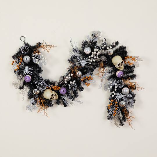 6ft. Artificial Halloween Black Garland with Skulls, Eyeballs & Spiders